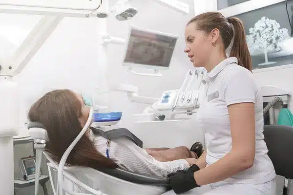 A dentist talking to her patient for sedation