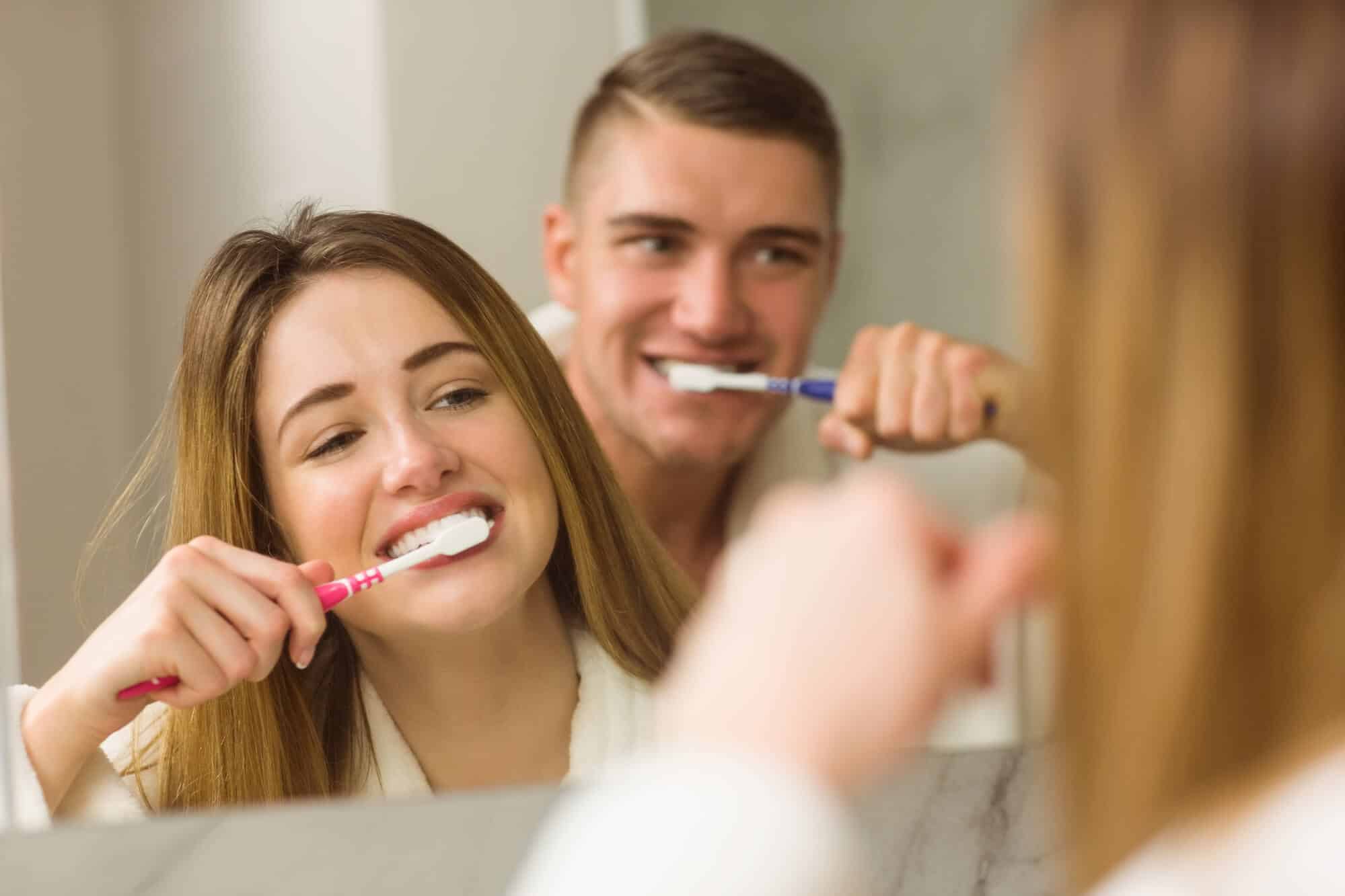couple brushing teeth