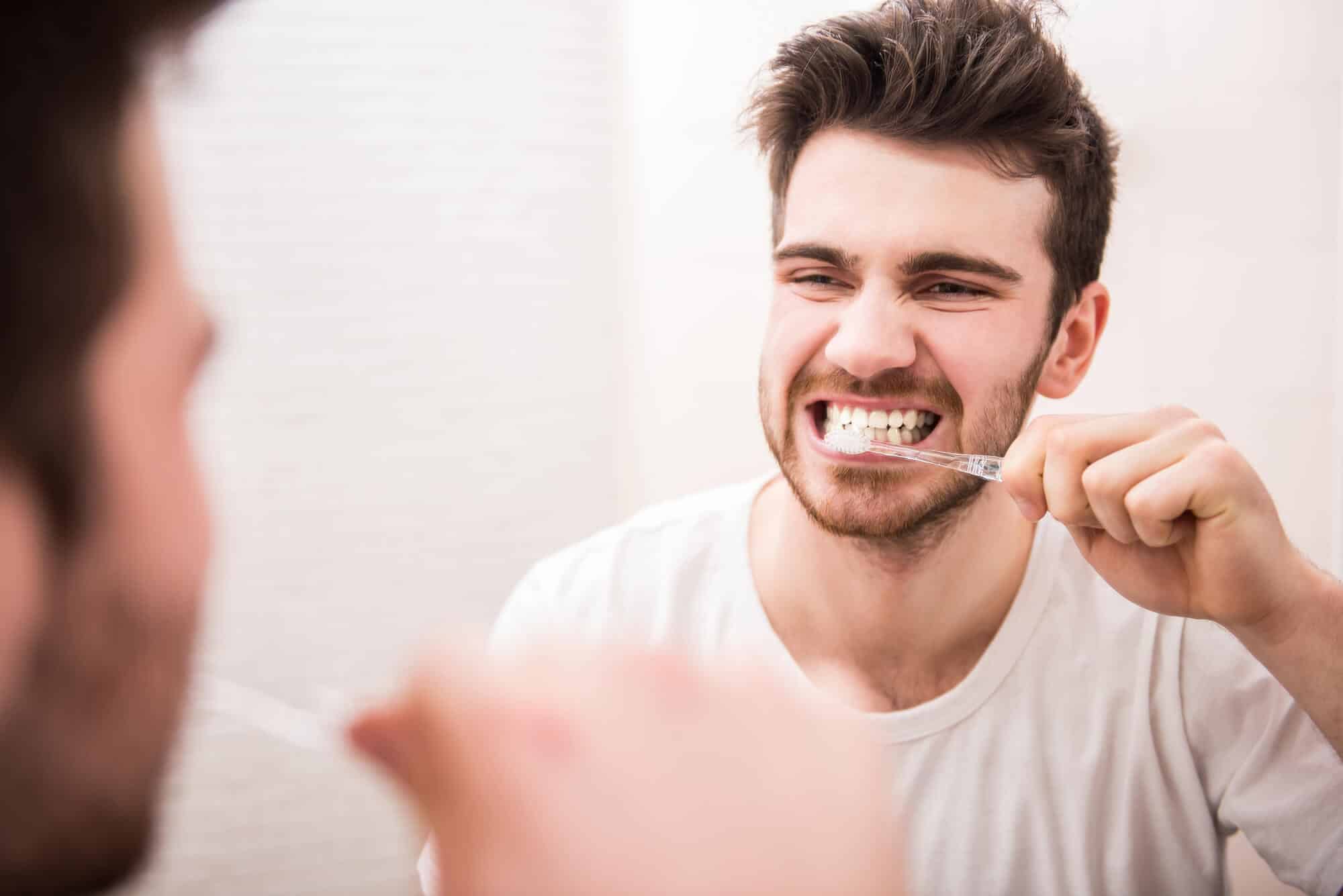 man brushing his teeth