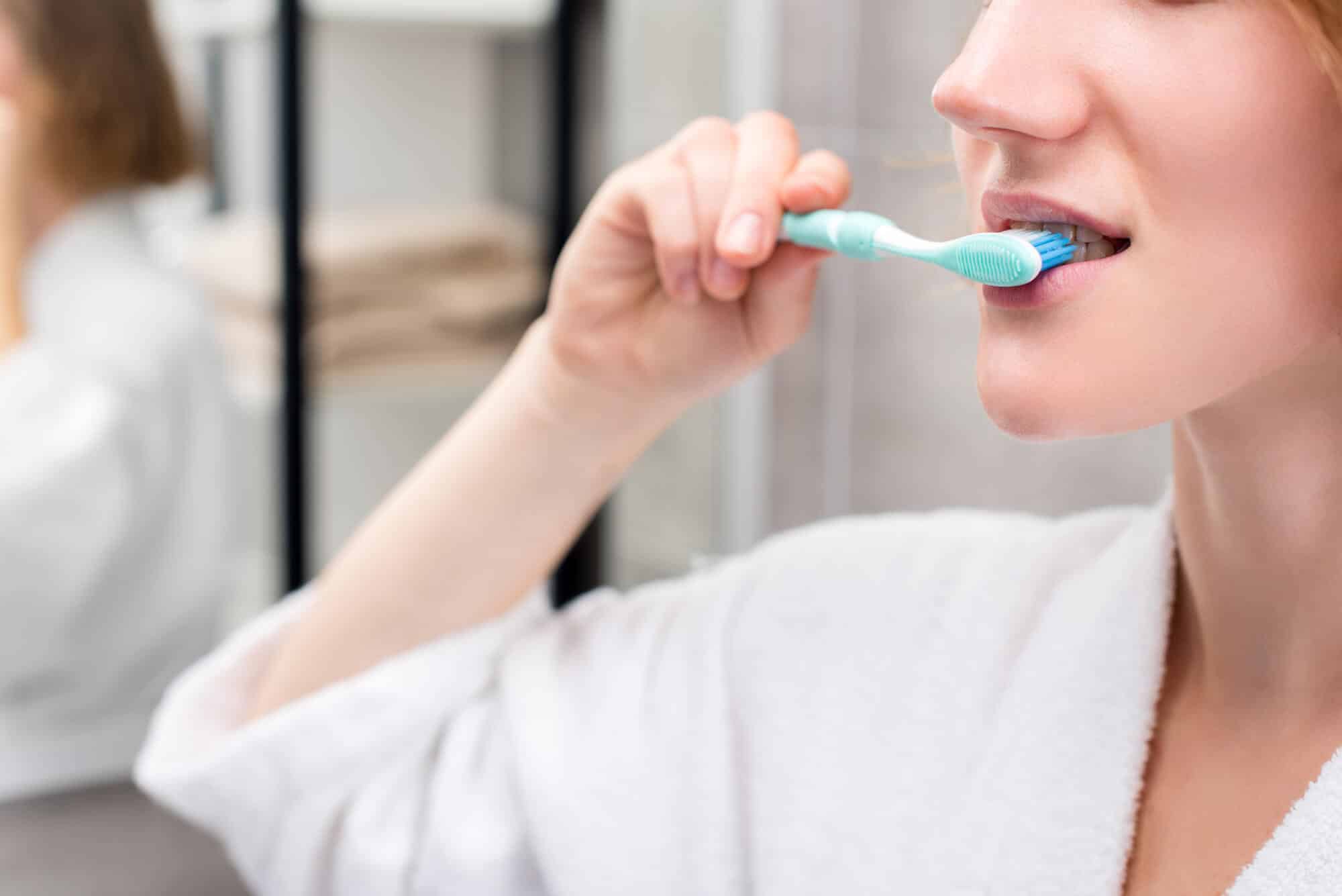 woman brushing her teeth