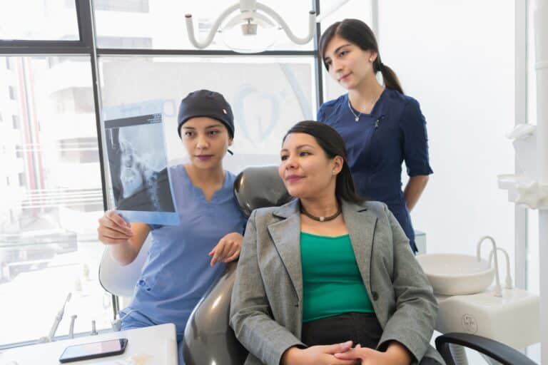 dentist with patient showing x ray tmj scaled