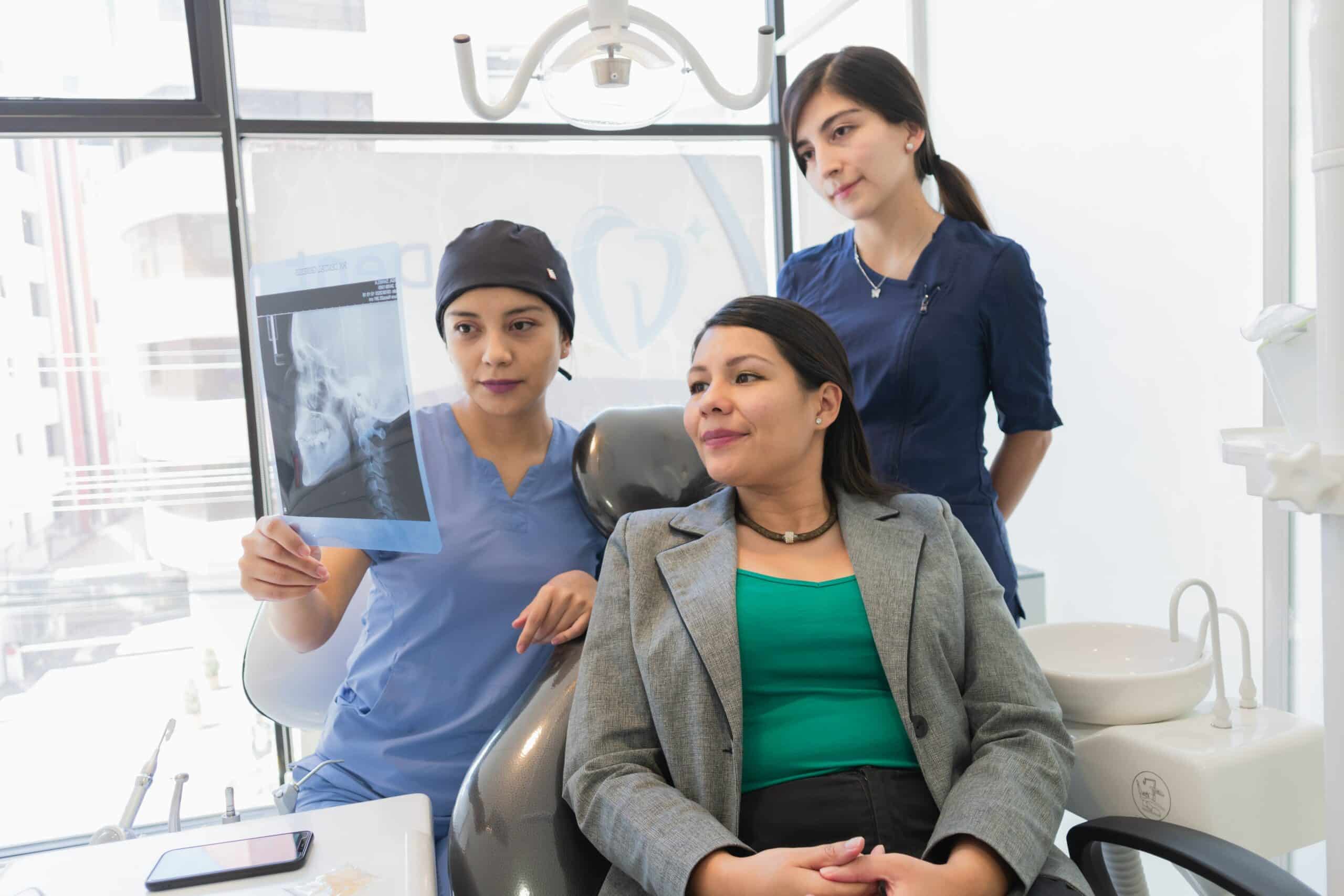 dentist with patient showing x ray tmj scaled